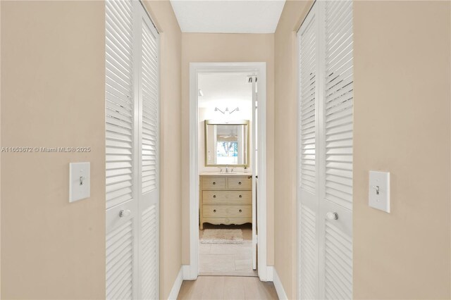 1516 S Lakeside Dr Unit 112, Lake Worth, FL 33460 - hallway featuring a sink and baseboards