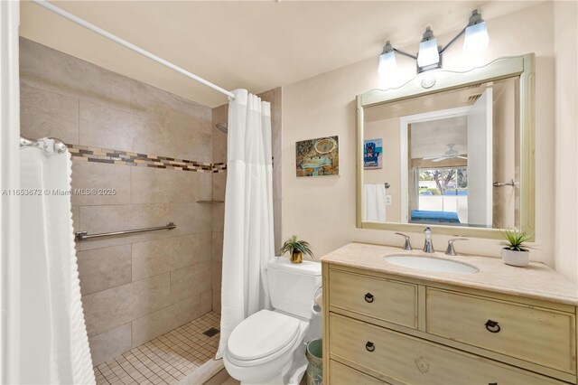 bathroom featuring a shower with shower curtain, vanity, and toilet