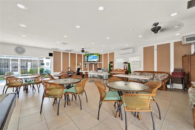 dining space featuring a textured ceiling, light tile patterned floors, and ceiling fan