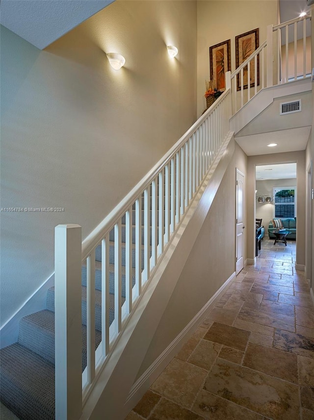 stairway with a towering ceiling