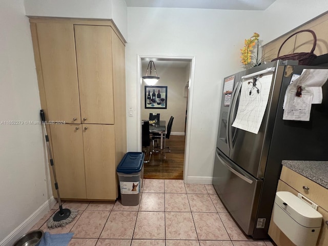 kitchen with stainless steel fridge with ice dispenser and light hardwood / wood-style floors