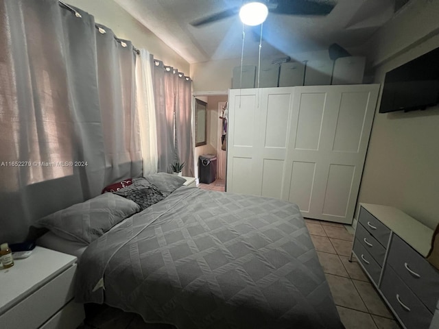 bedroom with ceiling fan and light tile patterned flooring