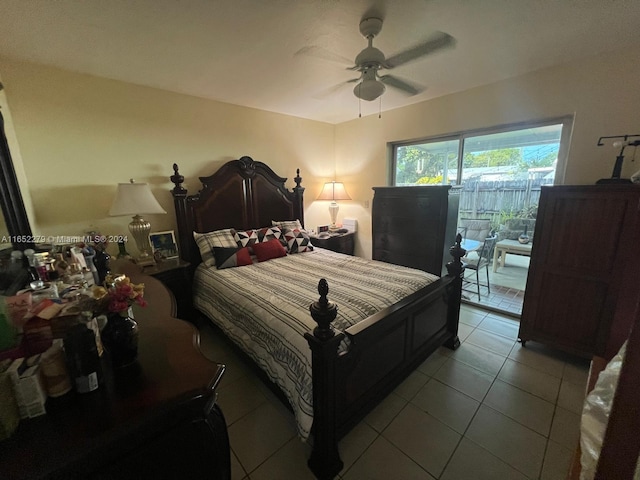 tiled bedroom featuring ceiling fan