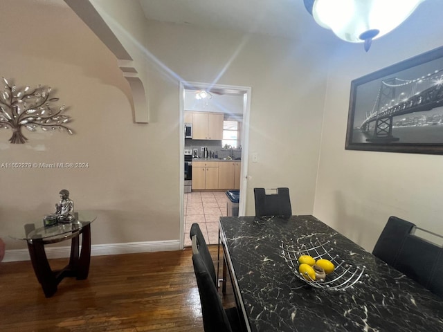 dining room with dark wood-type flooring and sink