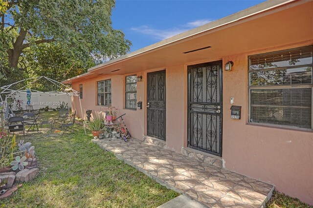 doorway to property featuring a lawn