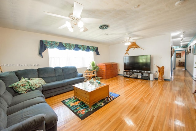 living room with light hardwood / wood-style floors and ceiling fan