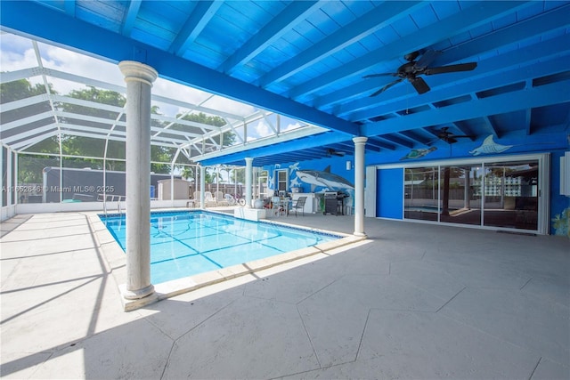 view of pool with a patio area, ceiling fan, and glass enclosure