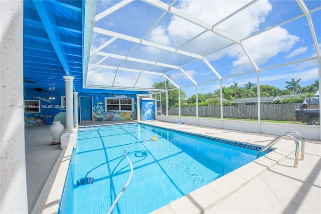 view of pool featuring a patio area, ceiling fan, and glass enclosure