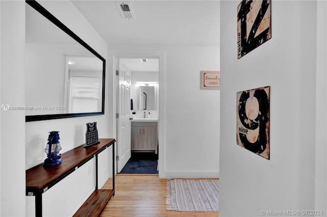 hallway with light hardwood / wood-style floors