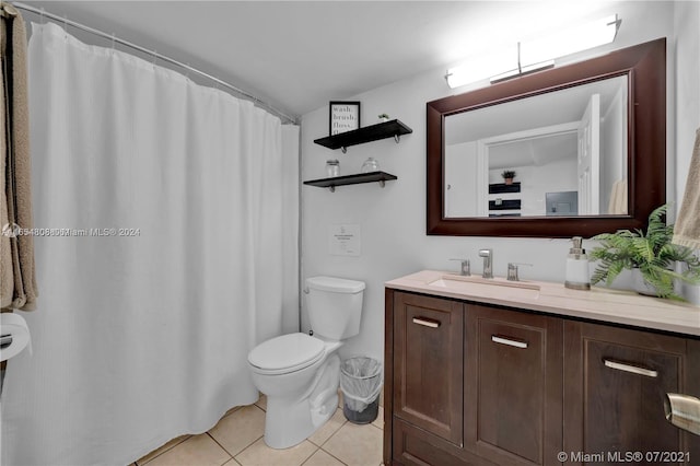 bathroom with tile patterned flooring, vanity, and toilet