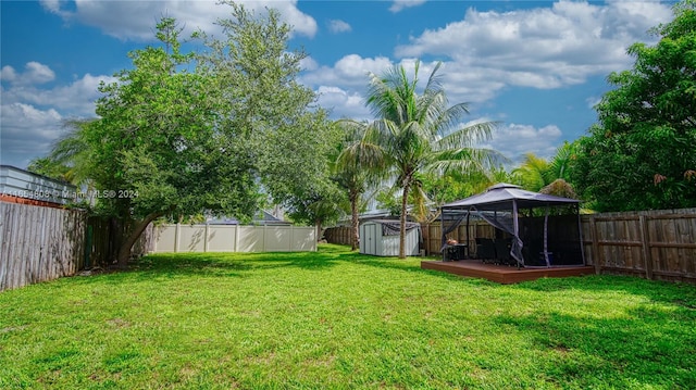 view of yard featuring a storage unit and a gazebo