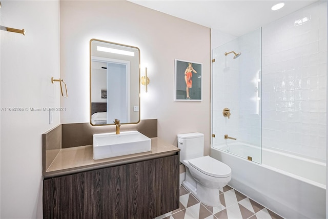 full bathroom with vanity, tiled shower / bath combo, toilet, and tile patterned flooring