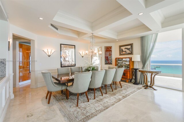 dining space with coffered ceiling, a water view, and beam ceiling