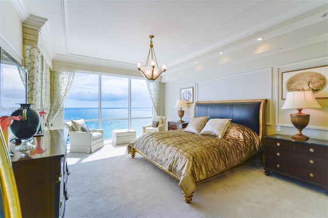 bedroom featuring ornamental molding, a notable chandelier, light carpet, and a water view