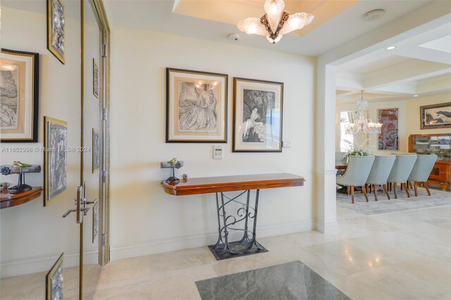 corridor with coffered ceiling, an inviting chandelier, and beam ceiling