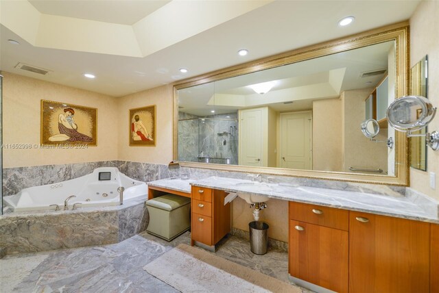 bathroom with vanity, a raised ceiling, and plus walk in shower