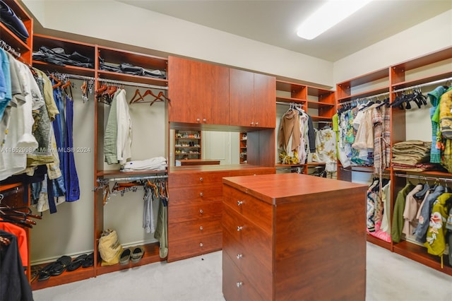 walk in closet featuring light carpet