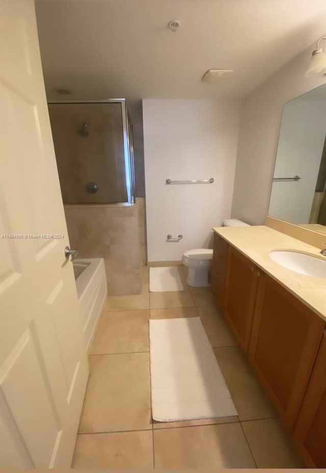 full bathroom featuring vanity, toilet, independent shower and bath, and tile patterned flooring