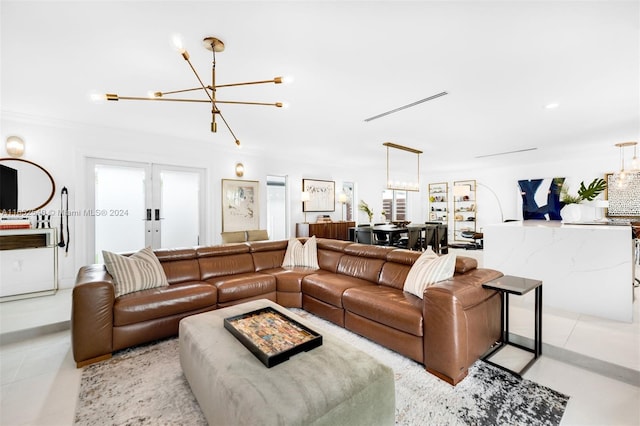 living room with light tile patterned floors, an inviting chandelier, and plenty of natural light