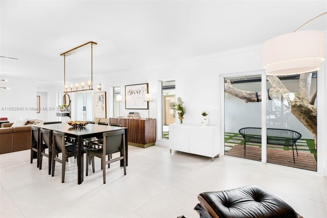 dining space with a wealth of natural light, crown molding, light tile patterned floors, and sink