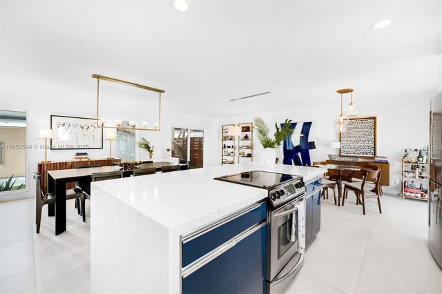 kitchen with a center island, sink, light tile patterned floors, pendant lighting, and white cabinets