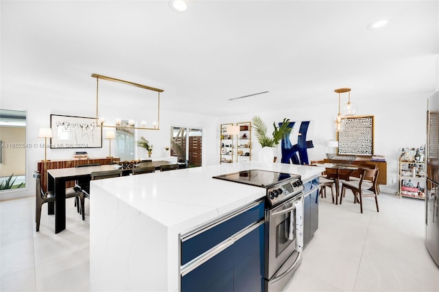 kitchen with stainless steel electric stove, blue cabinetry, light tile patterned floors, decorative light fixtures, and a center island