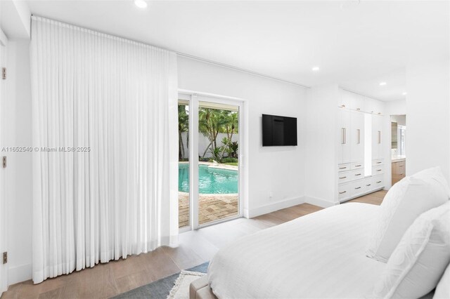 bedroom featuring access to exterior and light wood-type flooring