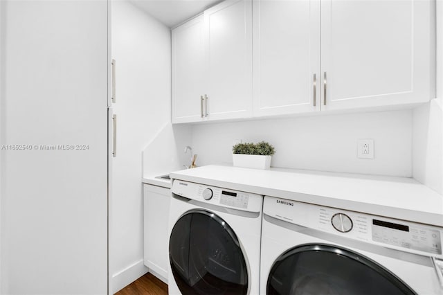 clothes washing area with washer and clothes dryer, cabinets, dark hardwood / wood-style floors, and sink