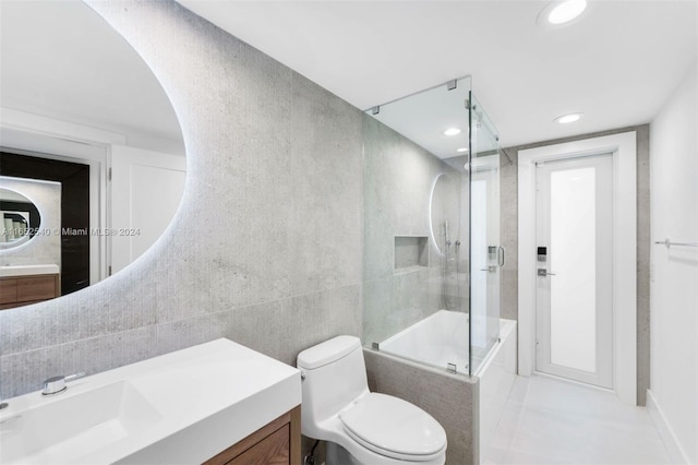 full bathroom with toilet, vanity, tile patterned floors, and enclosed tub / shower combo