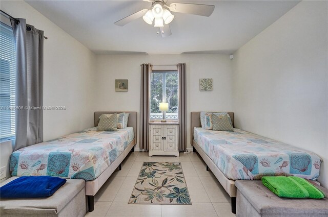 bedroom with ceiling fan and light tile patterned floors