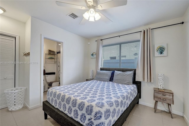 bedroom featuring light tile patterned flooring, ceiling fan, and ensuite bathroom