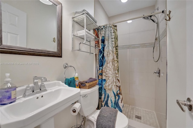 bathroom with sink, toilet, and walk in shower