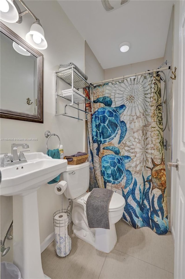 bathroom featuring toilet and a shower with shower curtain