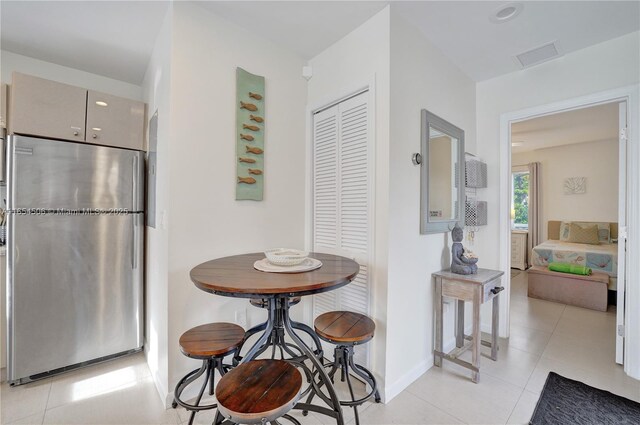 kitchen with stainless steel fridge and light tile patterned floors