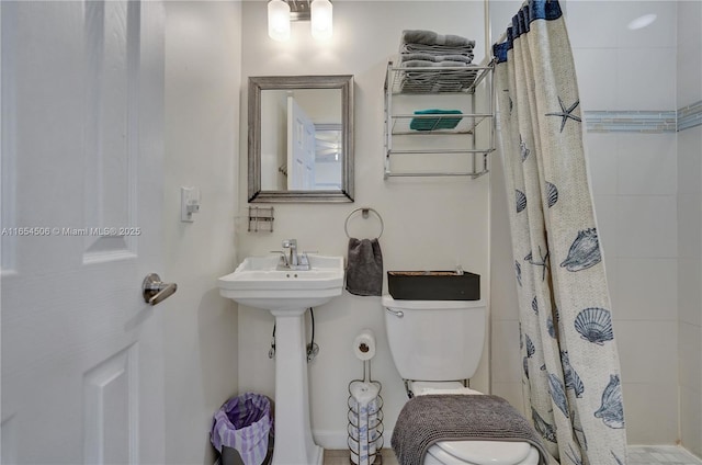 bathroom with a shower with curtain and toilet