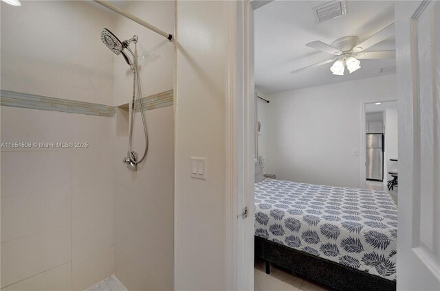 bedroom featuring stainless steel fridge and ceiling fan