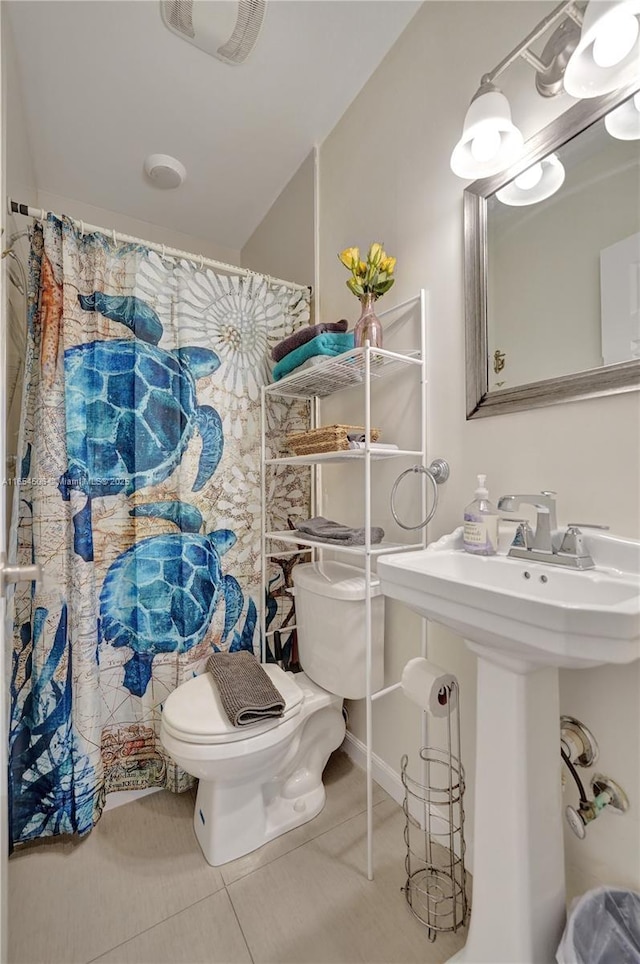 bathroom featuring tile patterned floors and toilet