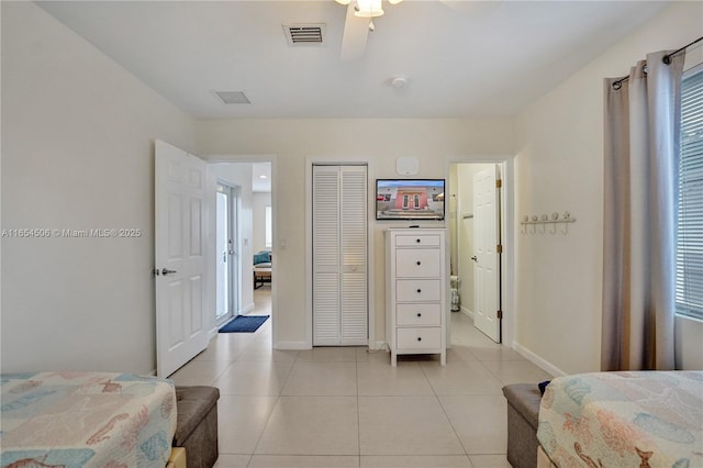 tiled bedroom featuring a closet and ceiling fan