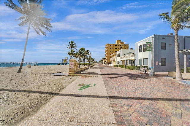 view of street featuring a water view and a view of the beach