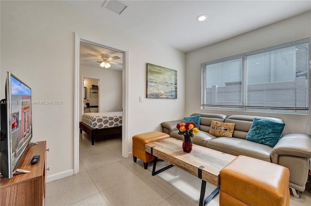 tiled living room featuring ceiling fan