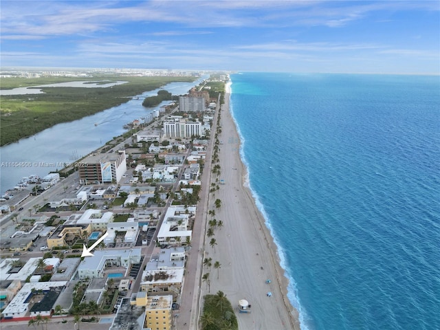 bird's eye view featuring a water view and a beach view