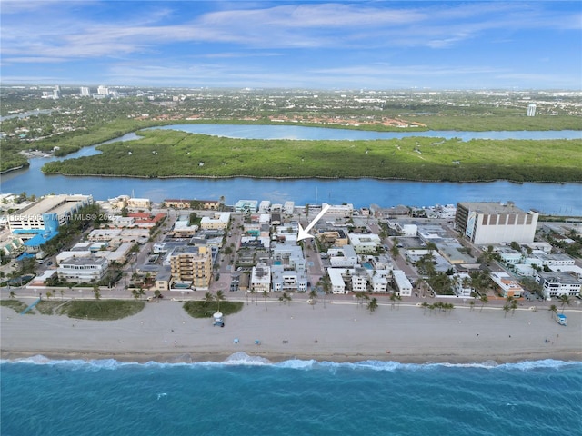 birds eye view of property with a water view and a view of the beach