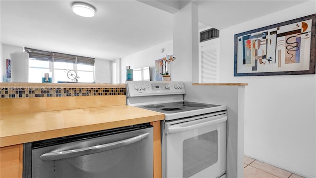 kitchen with white range with electric stovetop, dishwasher, and light tile patterned flooring