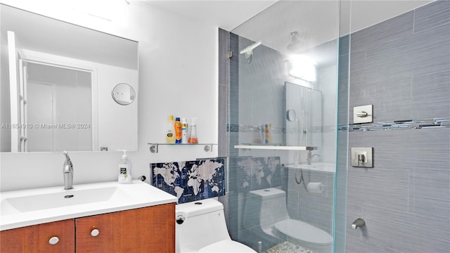 bathroom featuring vanity, toilet, and a tile shower