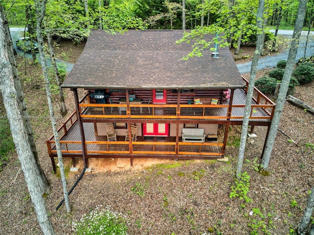 rear view of property with a wooden deck