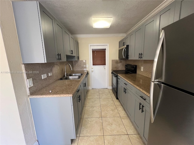 kitchen with decorative backsplash, gray cabinets, sink, and stainless steel appliances