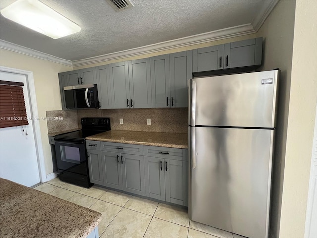 kitchen featuring crown molding, gray cabinets, decorative backsplash, light tile patterned flooring, and appliances with stainless steel finishes