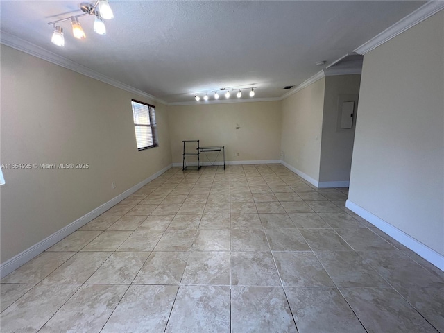 spare room featuring a textured ceiling, crown molding, and light tile patterned flooring