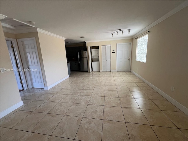 empty room featuring light tile patterned flooring and ornamental molding