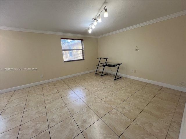 tiled empty room with a textured ceiling, rail lighting, and crown molding